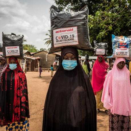 Women wearing face masks receive food support from ActionAid in Nigeria